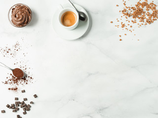 Sweet flat lay background. Chocolate, sugar, hazelnut cocoa spread, cocoa powder and coffee cup on...