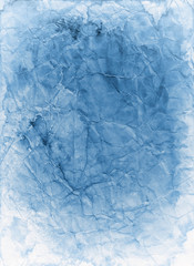 Old blue paper background texture that is faded stained and crumpled in a distressed vintage grunge parchment design
