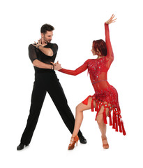 Passionate young couple dancing on white background