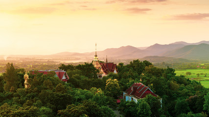 Scenic giant photo Buddha statue in sunset time in famous Thailand Temple Wat Phra That Doi Saket...