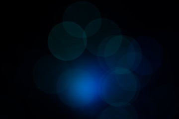 Colorful blue lens flares with beautiful bokeh on black background