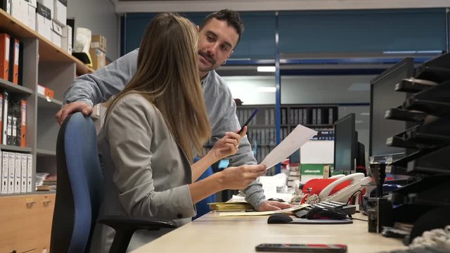 Office manager giving instructions to workmate