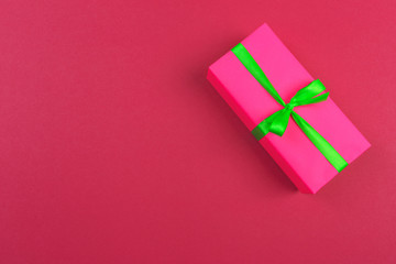 Gift box with ribbon and bow on color background and space for text. Top view - Image