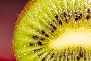 Seeds on a sliced green kiwi as a background