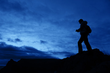 Silhouette of a person on the sky background.