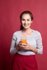 Young Asian woman drink orange juice.