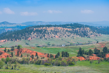 Naklejka premium A naturally formed red sandstone rocks in Devils Tower National Monument, Wyoming