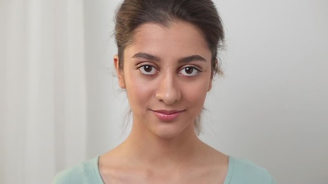 Portrait of a beautiful Indian young woman. Close-up of the face of a smiling asian teenager girl.