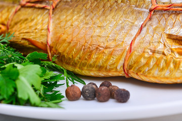 Smoked fish on plate close up