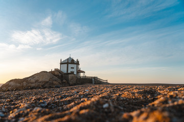 Fototapeta premium A church on the shore of the Atlantic ocean in Portugal sunset