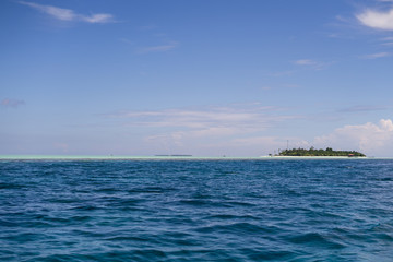 Dark blue and turquoise green with small island in Semporna, Borneo, Sabah.