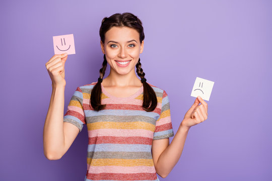 Photo Of Funny Lady Holding Paper Emoticons Good And Bad Mood Recommending Positive Emotions Wear Casual Striped T-shirt Isolated Pastel Purple Color Background