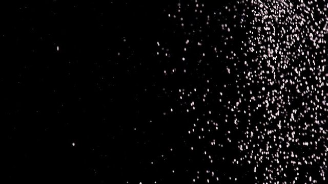 White Particles Fall. White particles quickly move down on black background