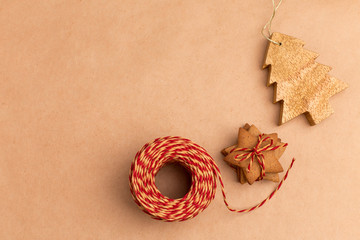 Fototapeta na wymiar New Year's cookies, red ribbon and wooden toy on craft paper