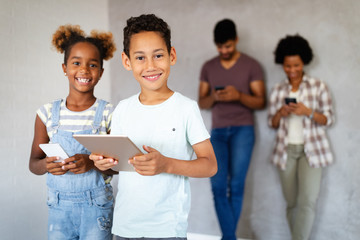 Happy african american family using technical devices, phone. tablet