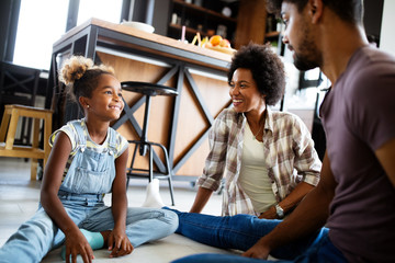 Happy family talking and smiling together at home