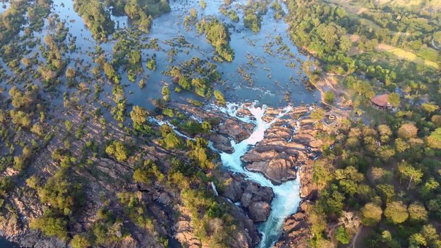 Four Thousand Islands In Mekong, Laos - Beautiful Scenery Of Water Flowing In The Rocky Stream Fringed With Green Trees - Aerial Top Shot
