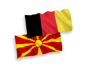 Fototapeta premium National vector fabric wave flags of North Macedonia and Belgium isolated on white background. 1 to 2 proportion.