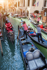 Fototapeta na wymiar Gondolas with gondoliers in Venice