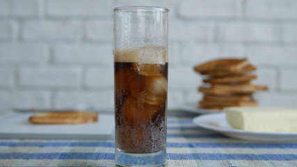 Image with a Glass Filled with Cube Ice and Effervescent Black Juice