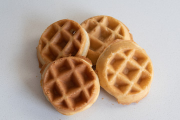 4 pieces of golden brown waffles isolated on white background. Morning breakfast baked food.