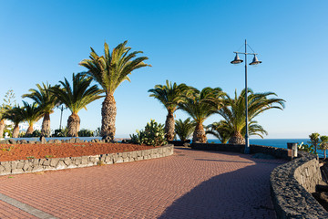 Playa Blanca resort famous winding coastal promenade along Atlantic Ocean shoreline. Lanzarote, Canaries Islands, Spain.