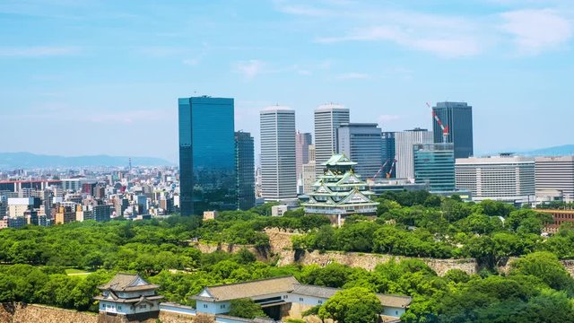 Osaka, Japam. Aerial view of Castle Park in Osaka, Japan with modern skyscrapers at the background. Time-lapse of moving clouds during the hot day with car and people traffic 