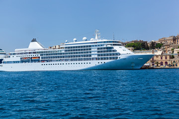 Fototapeta na wymiar A modern syperyacht in the port on sunny day, Malta