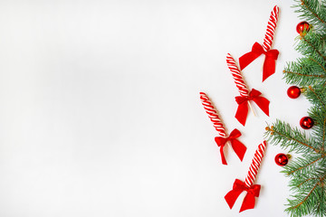 Creative minimal Christmas art. Border made with Christmas candies on white background. Flat lay. Copy space. Minimal composition.