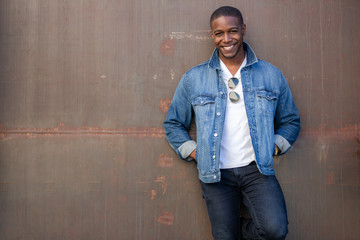 Stylish fashion casual dressed African American male, trendy jeans jacket, happy and cheerful pose