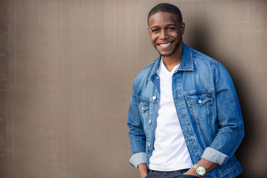 Handsome african american man model, good looking smiling casual lifestyle portrait in trendy clothing