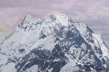 Obraz premium Mountain landscape with a beautiful peak in the rays of the setting sun