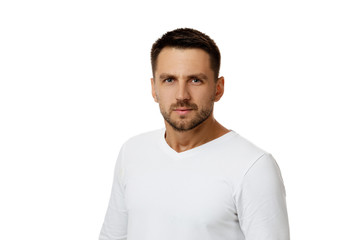 Fototapeta premium man gazes steadily. Close-up portrait of handsome bearded man in white shirt looking at camera isolated on white background