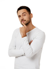 portrait of doubtful bearded man in casual white shirt asking questions isolated on white...