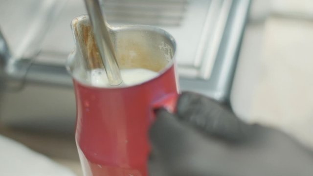 Barista makes coffee on a coffee machine, slow motion close-up.