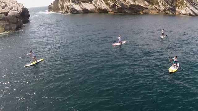A Beautiful Scenery Of Tourists  Enjoying in the Paddle Board at Baleal Island - Aerial Shot
