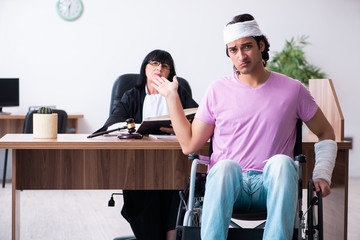 Disabled man consulting judge for damages litigation