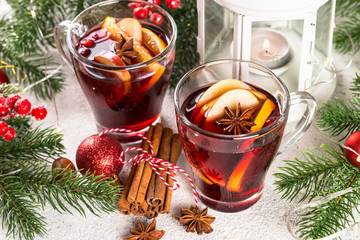 Mulled wine with christmas decorations on white.