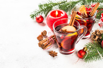 Mulled wine with christmas decorations on white.