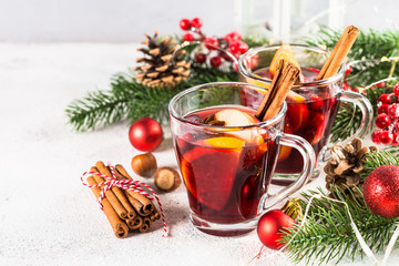 Mulled wine with christmas decorations on white.