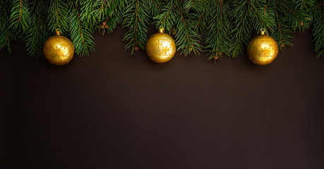Christmas background with festive decoration. Branches of coniferous trees with gold decorations. Merry Christmas and Happy New Year. Flat lay, copy space for your text.