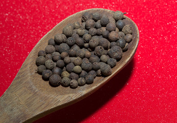 the texture of the pepper, sweet peas close-up on red background, condiments and spices