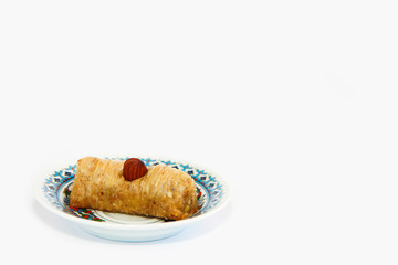 national oriental sweet baklava on a decorative plate on white background