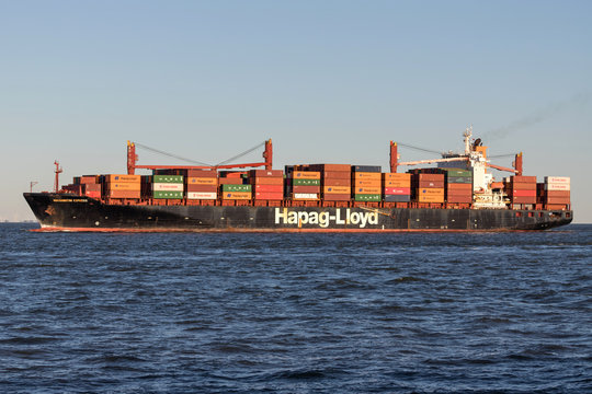 CUXHAVEN, GERMANY - OCTOBER 29, 2019: Hapag-Lloyd container ship WASHINGTON EXPRESS on the river Elbe. Hapag-Lloyd AG is a transnational German-based transportation company.