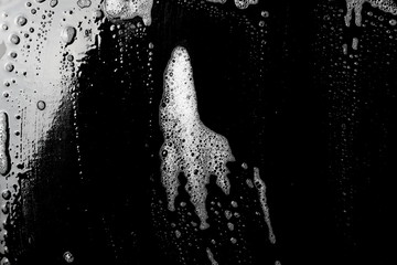 Obraz premium Soap foam, lather isolated on black surface with clipping path, texture and background, top view