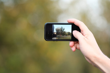 male hand holds the phone. mobile photography.