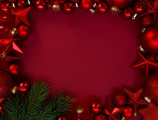 Christmas frame with a red ornament on a red background. Christmas, winter, new year concept. Top view with copy space for text.