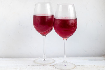 Two glasses with red wine. On white background.