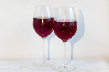 Two glasses with red wine. On white background.