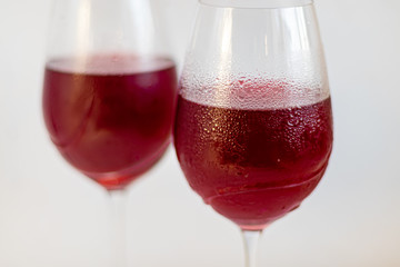 Two glasses with red wine. On white background.